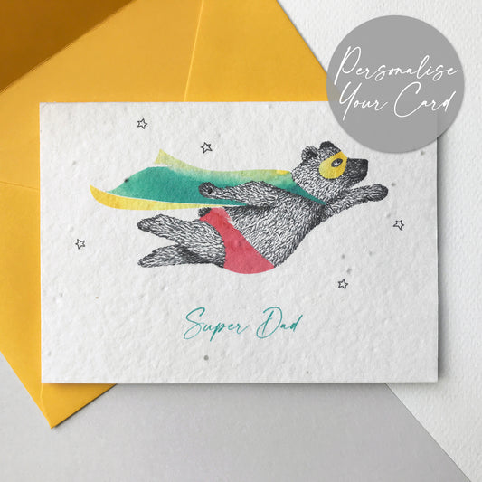 Bloom Cards plantable seed paper Super Dad card with black and white pen illustration of a flying super bear wearing a turquoise and yellow cape and red underpants. There are small outline stars around him and the text underneath is turquoise and reads Super Dad. The card is printed onto recycled paper embedded with seeds that can be planted to grow wildflowers. The card is blank inside, has planting instructions printed on the back and comes with yellow eucalyptus paper envelope.