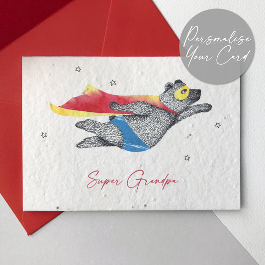 Bloom Cards plantable seed paper Super Grandpa card with black and white pen illustration of a flying super bear wearing a red and yellow cape and blue underpants. There are small outline stars around him and the text underneath is red and reads Super Grandpa. The card is printed onto recycled paper embedded with seeds that can be planted to grow wildflowers. The card is blank inside, has planting instructions printed on the back and comes with a recycled red envelope. Handmade by Suzanne Marie Paperie.