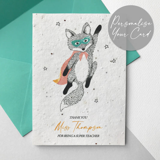 Photo of a personalised Super Hero Teacher plantable wildflower seed card in mint. The card has a pen and watercolour flying superhero fox wearing a cape and mask. Text reads Thank You Name For Being A Super Teacher. The card comes with a mint coloured eucalyptus paper envelope.