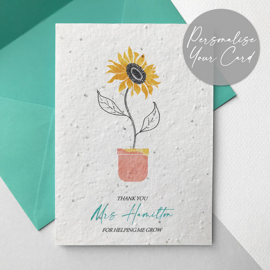 Photo of a personalised Thank You for Helping Me Grow plantable wildflower seed card in mint. The card has a pen and watercolour sunflower design. Text reads Thank You Name For Helping Me Grow. Personalise your card with any name. The card comes with a mint eucalyptus paper envelope.