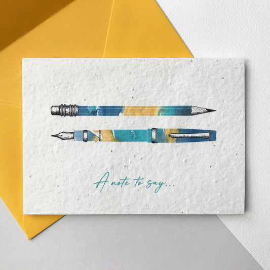 Image of an A6 Bloom Cards plantable note card featuring a hand illustrated design. Watercolour washes in turquoise, blue and yellow are used to create this modern pen and pencil design with pen drawn details. The turquoise text underneath reads 'A Note To Say'. This recycled cotton card is printed onto wildflower seed paper, so your recipient can grow their card and enjoy growing beautiful flowers. The card comes with a matching yellow fsc certified eucalyptus envelope. Handmade by Suzanne Marie Paperie.