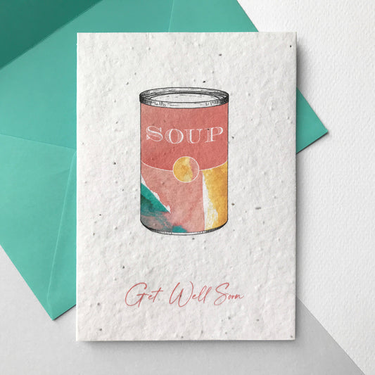 Image of a Bloom Cards A6 plantable get well soon card featuring a colourful hand illustrated soup tin design. Washes of coral, mint and yellow watercolour make a colourful tin with pen drawn details and the word 'Soup' on the front. The coral text underneath reads 'Get Well Soon'. Printed onto eco-friendly paper made from recycled cotton and embedded with wildflower seeds. The card comes with a matching mint fsc certified eucalyptus envelope.